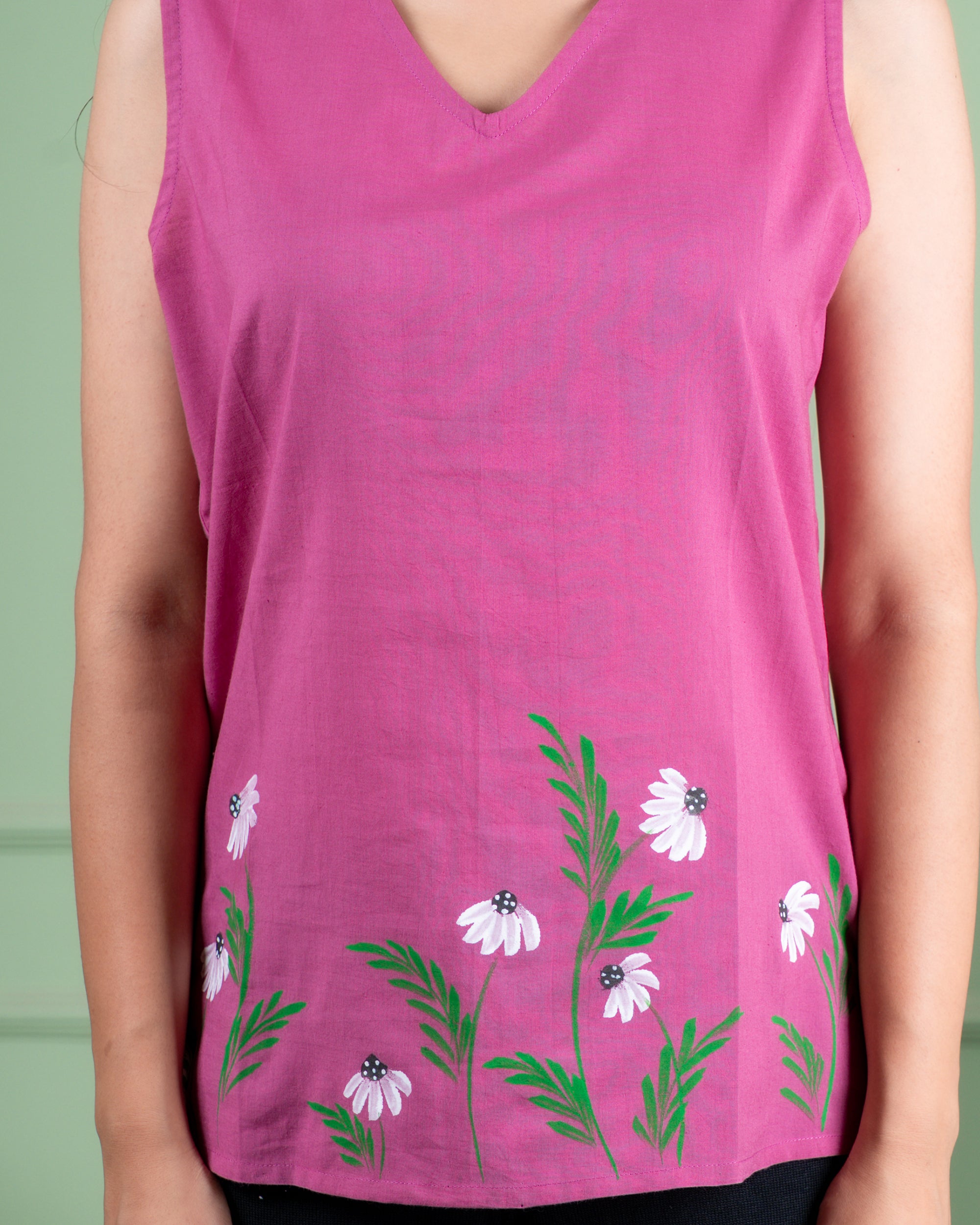 Hand-painted cotton top with delicate floral artwork in soft colors