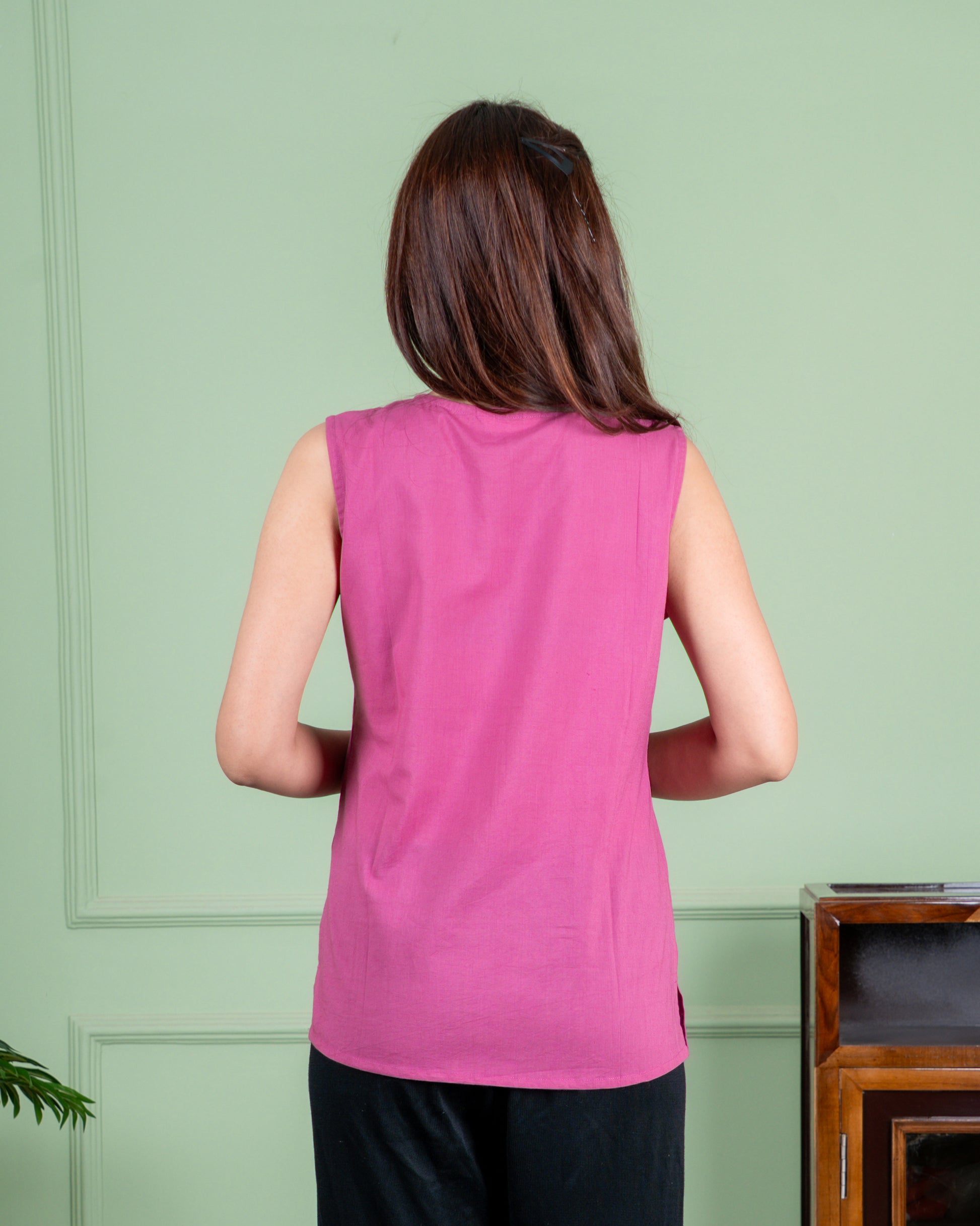 Hand-painted cotton top with delicate floral artwork in soft colors