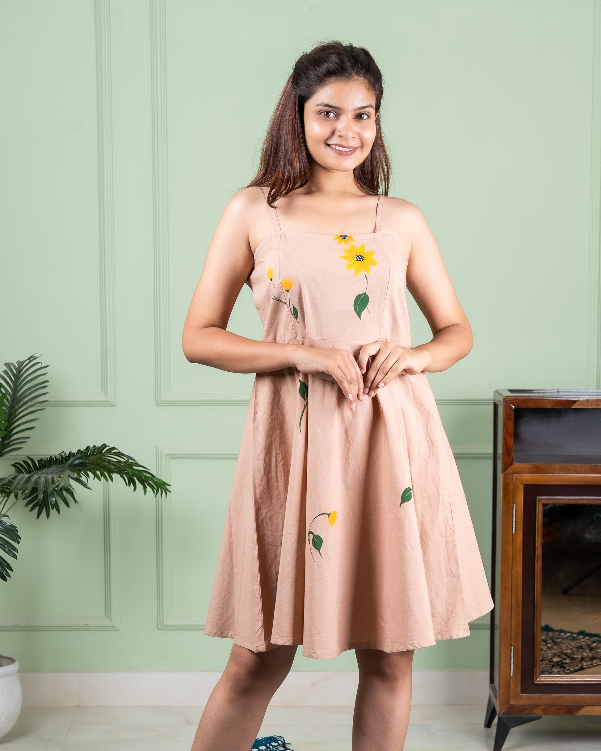 Hand-painted cotton dress with delicate floral artwork in soft colors