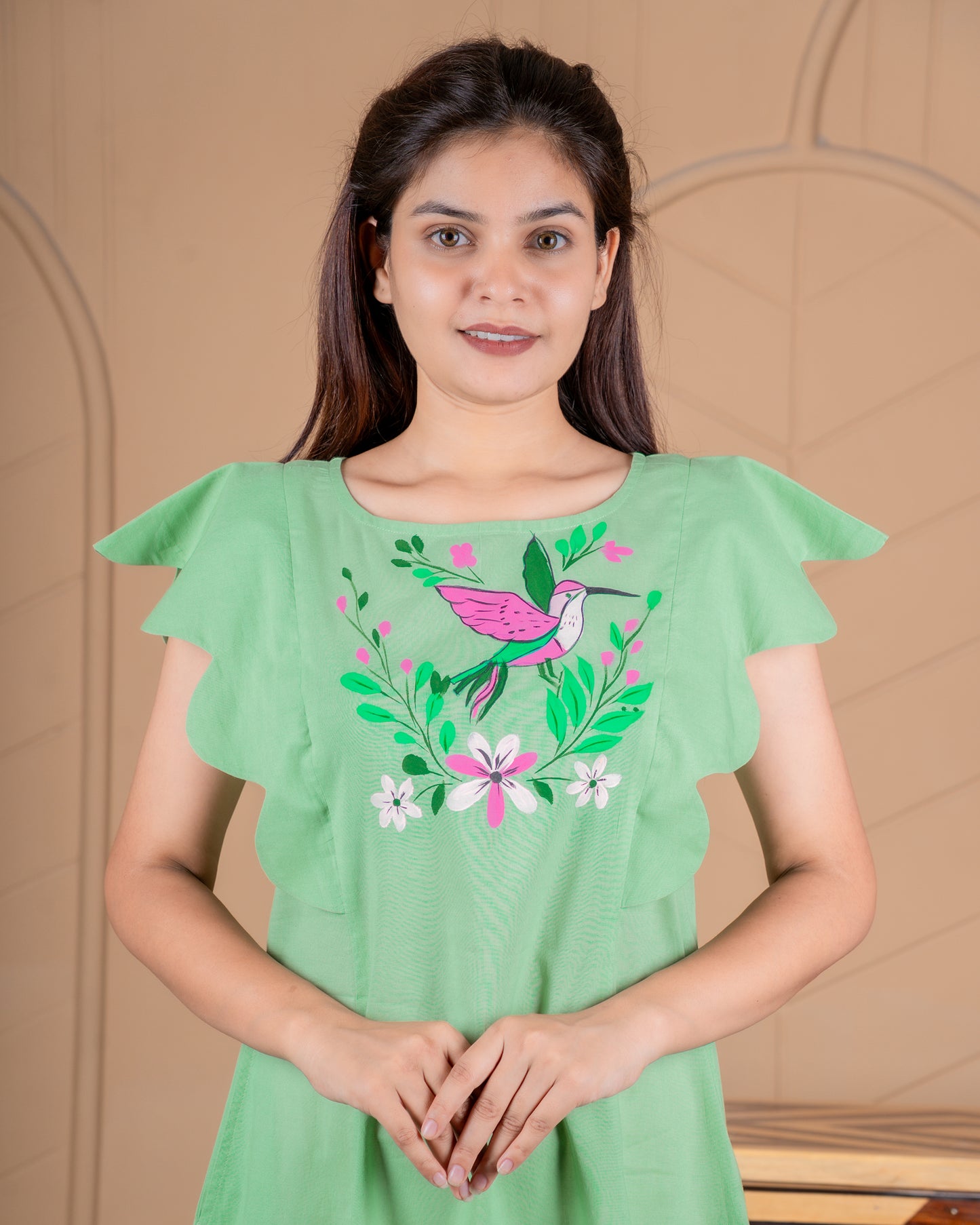 Hand-painted cotton dress with delicate floral artwork in soft colors