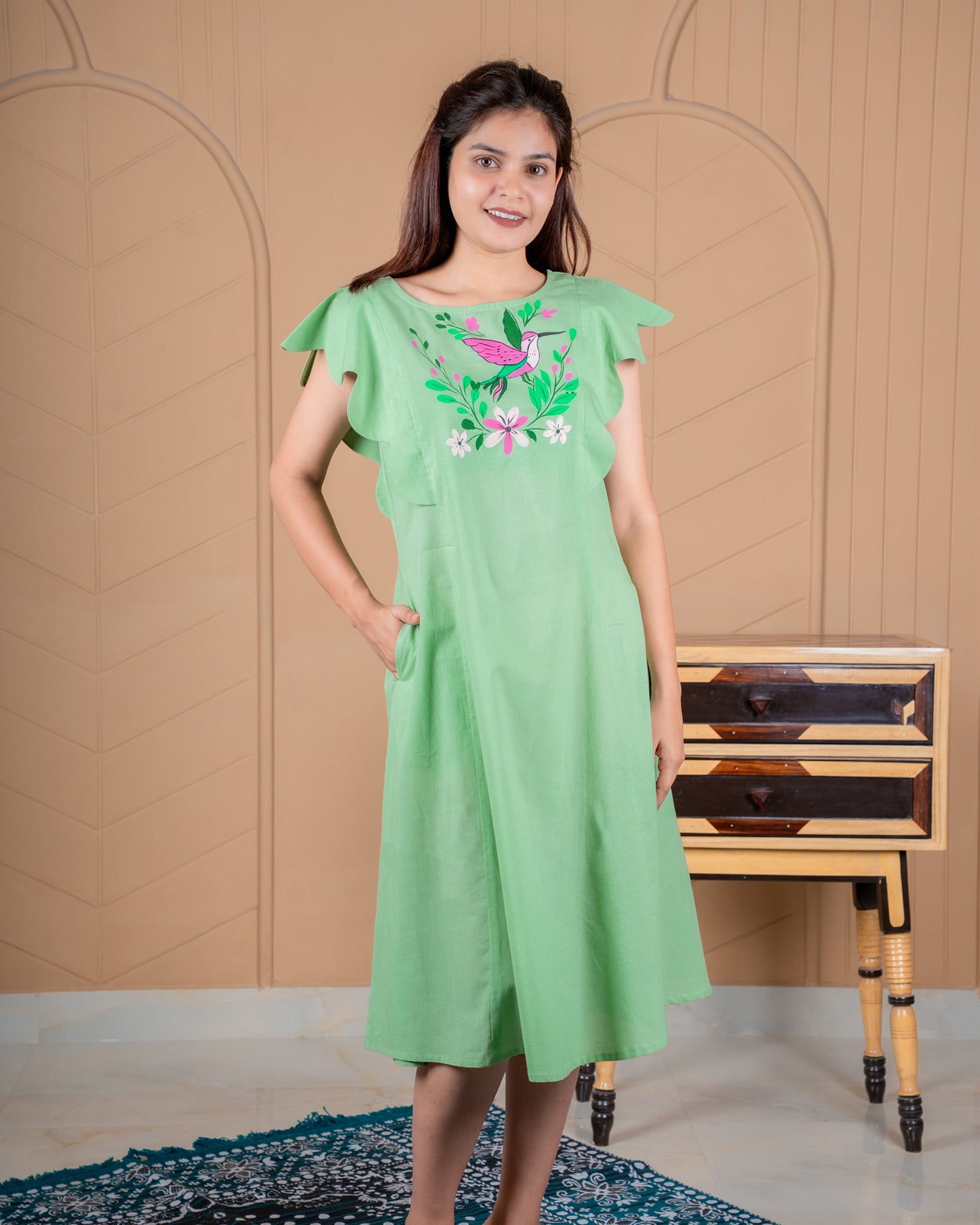 Hand-painted cotton dress with delicate floral artwork in soft colors