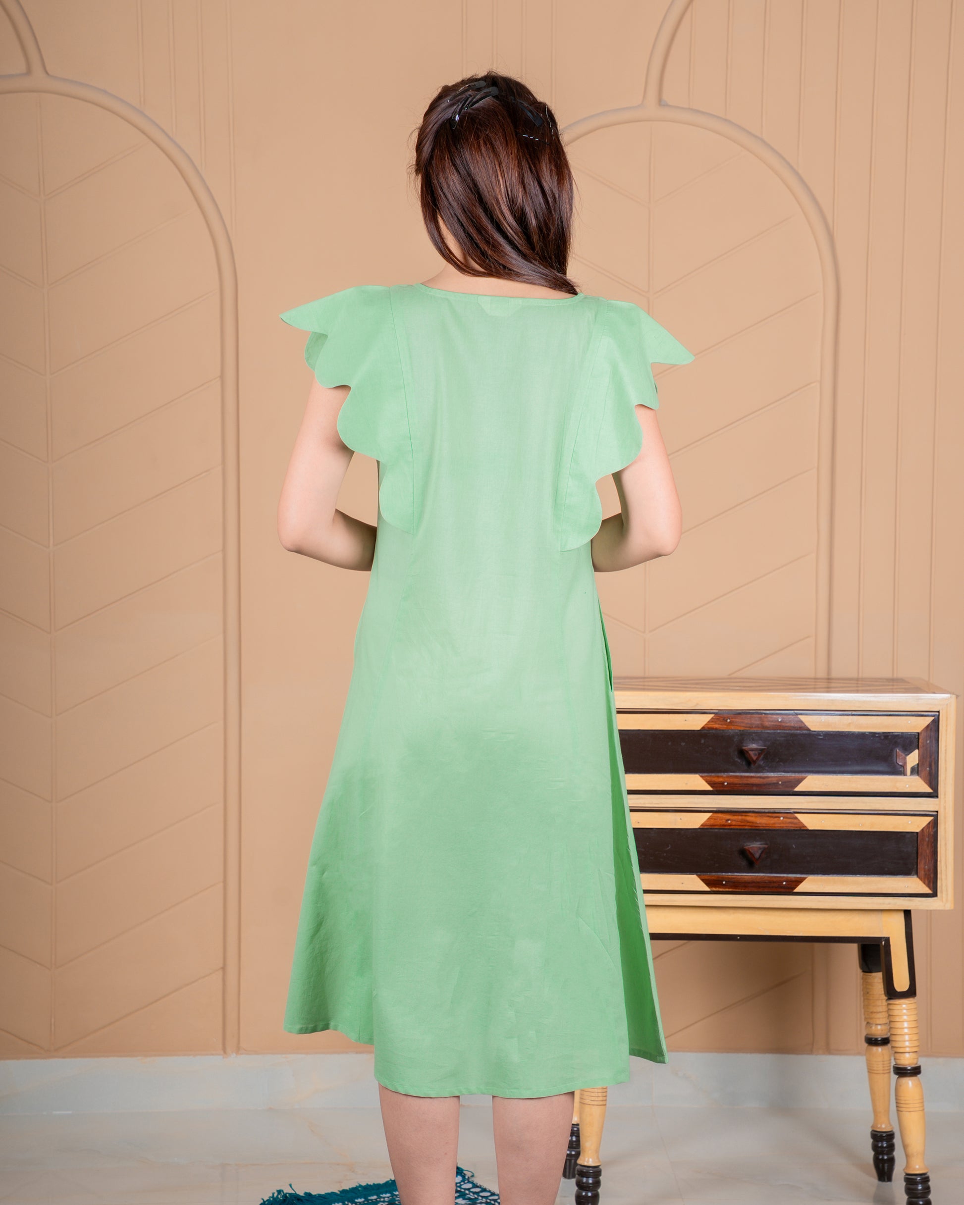 Hand-painted cotton dress with delicate floral artwork in soft colors