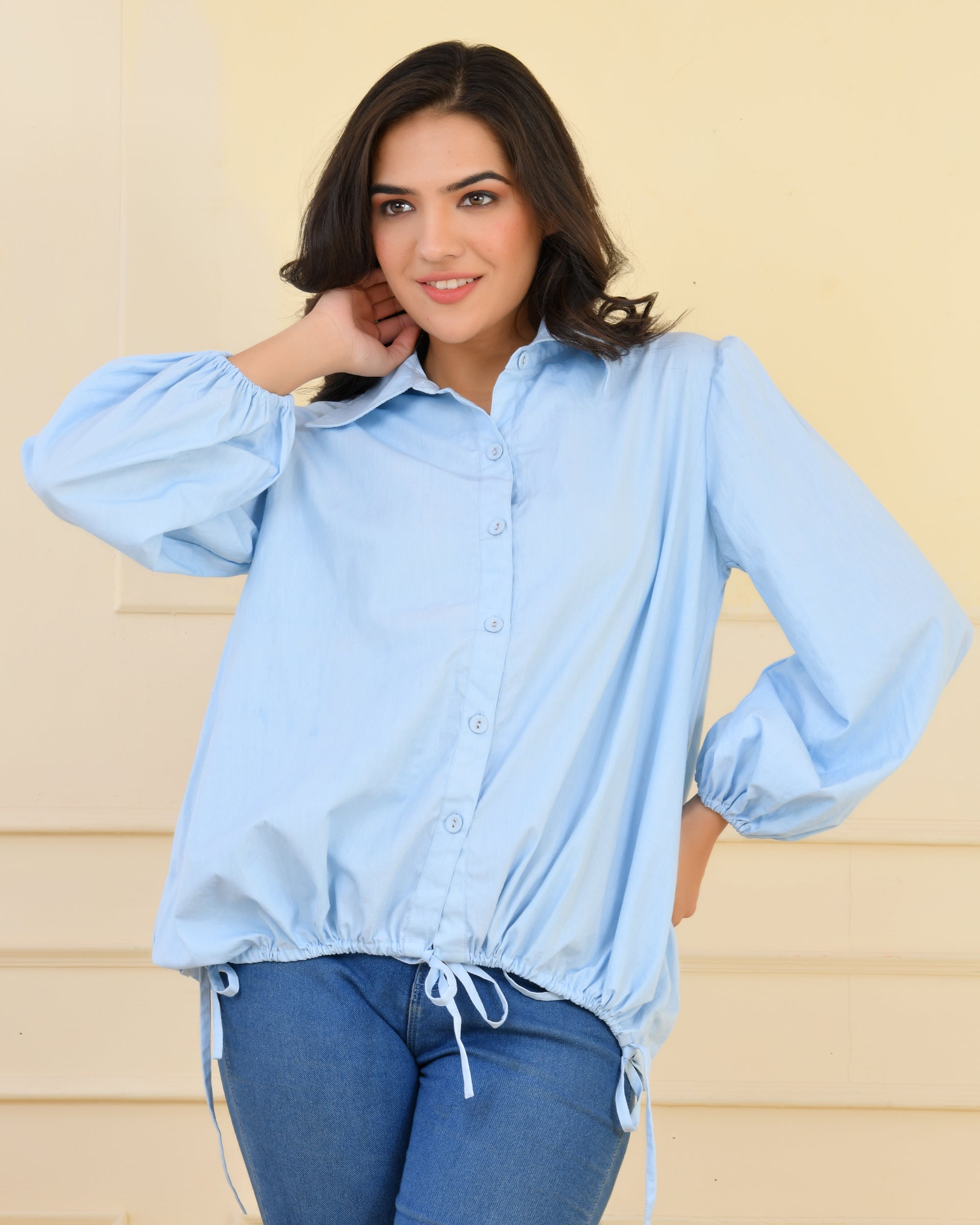 Poplin shirt with smocking at back, balloon sleeves, and tie-up strings on sleeves and hem for a balloon silhouette