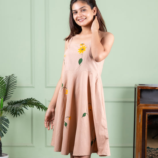 Hand-painted cotton dress with delicate floral artwork in soft colors