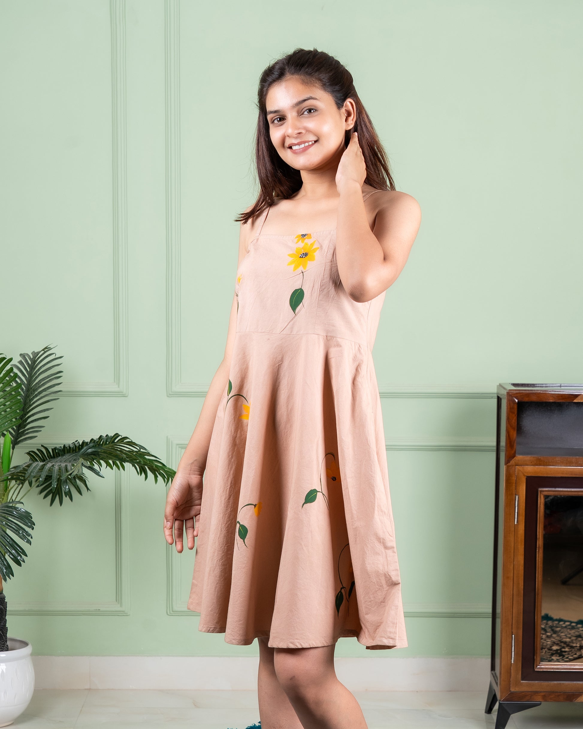 Hand-painted cotton dress with delicate floral artwork in soft colors